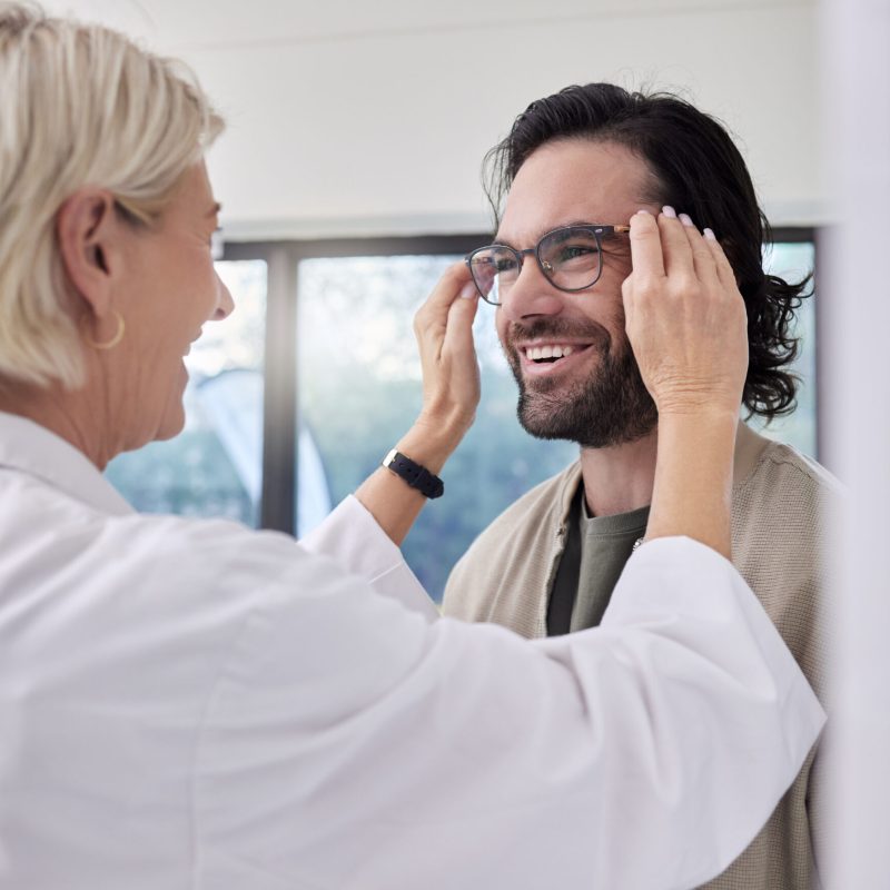 Optician, glasses and man in store for vision, eyesight and optical frames. Happy customer face, op.